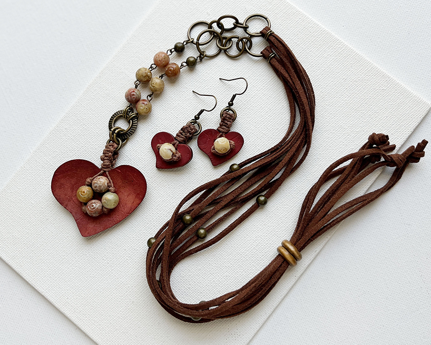 Boho-style jewelry set with earthy tones: heart-shaped coconut pendant, faux suede cord, and stone beads