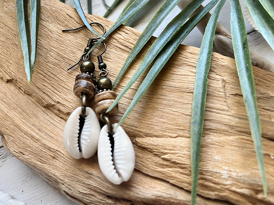 Stylish cowrie shell earrings displayed with a tropical touch