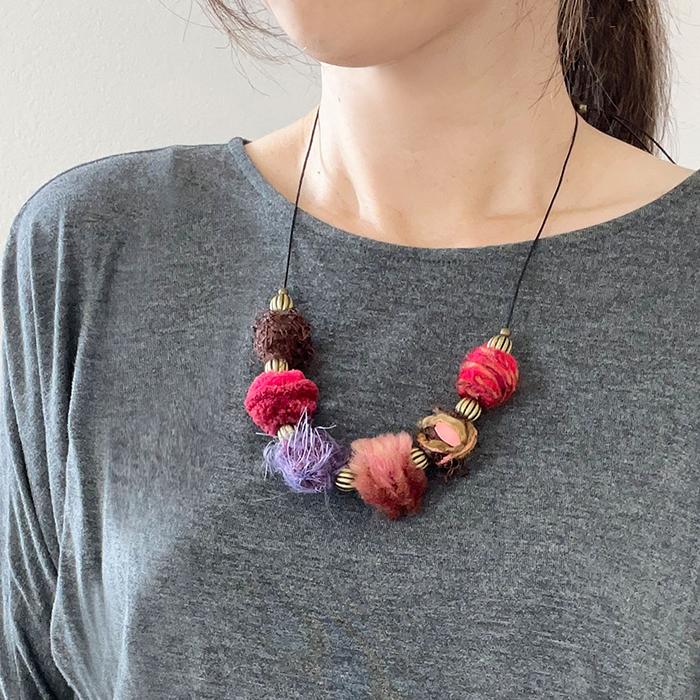 Shades of red yarn wrapped bead statement necklace