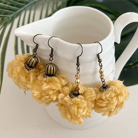 Two pairs of yellow yarn ball bead earrings